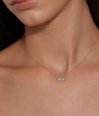 Model wearing aqua blue three-stone necklace