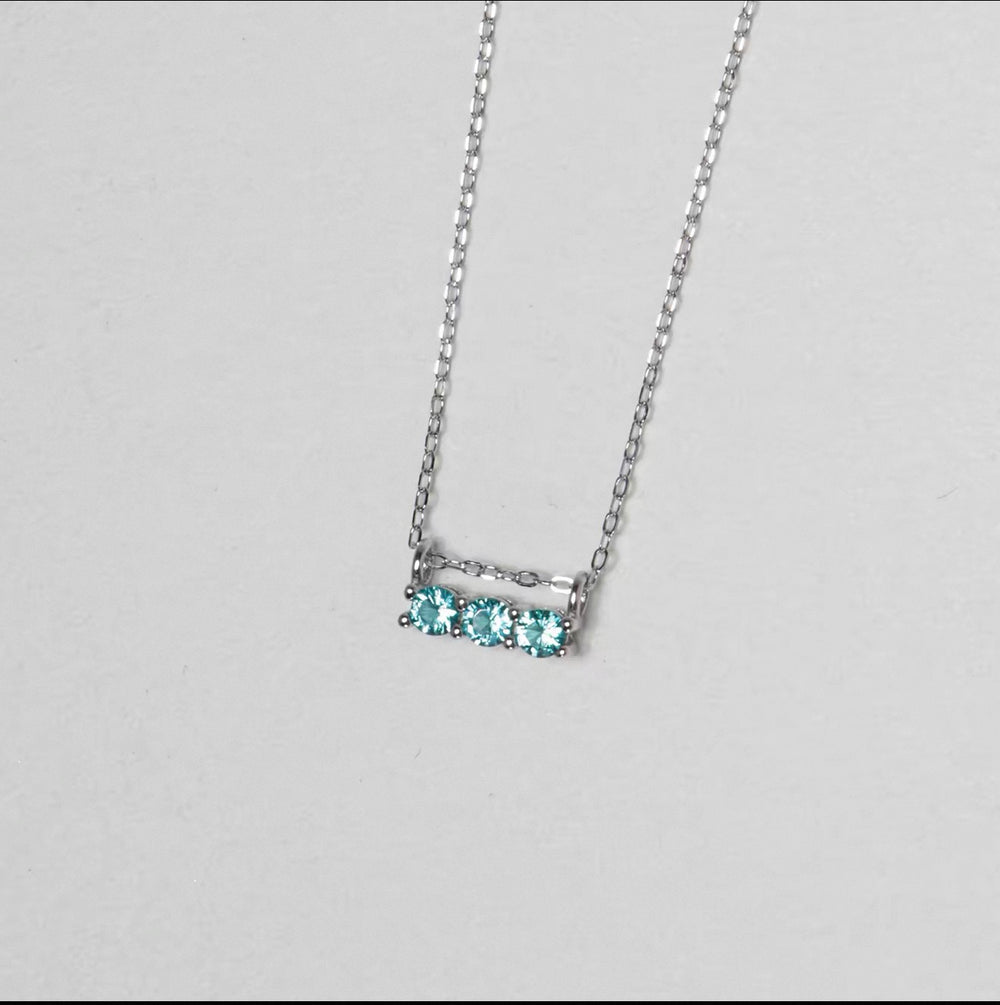 Silver necklace with three round aqua blue zirconia stones