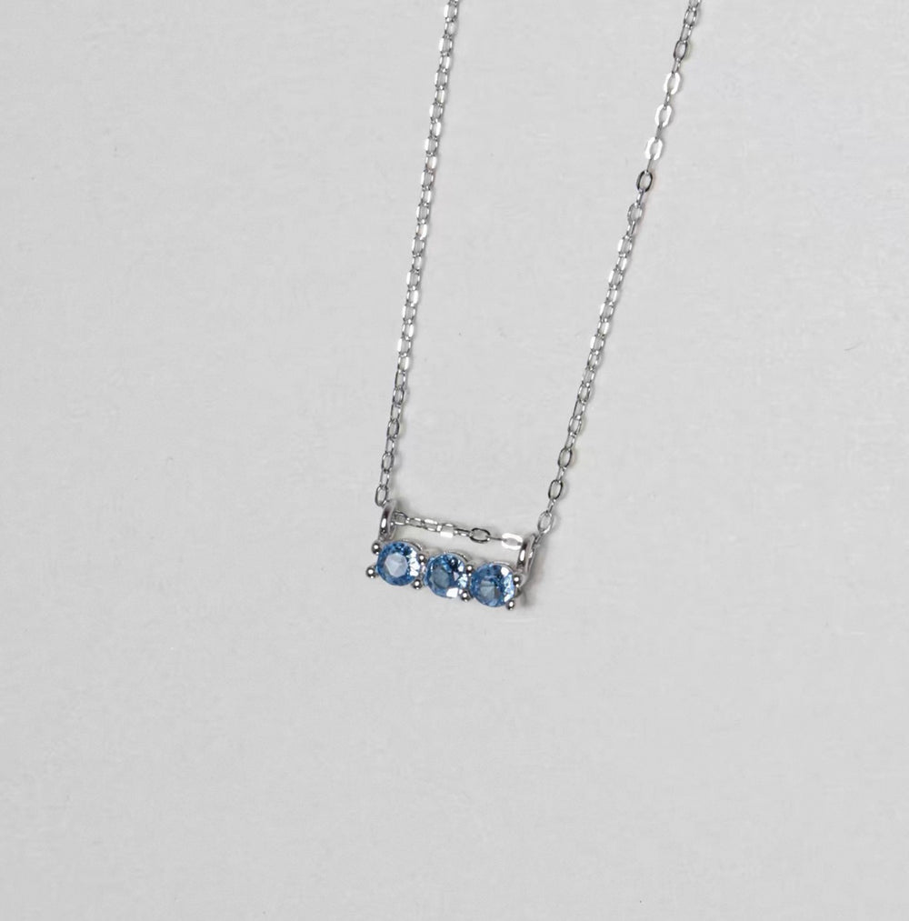 Silver necklace with three round blue zirconia stones
