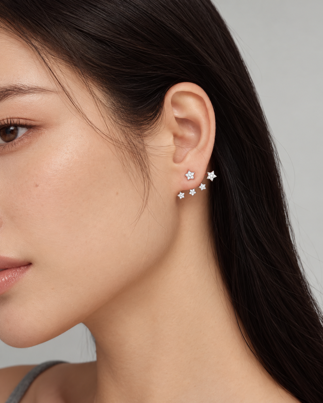 Celeste silver star earrings worn on ear