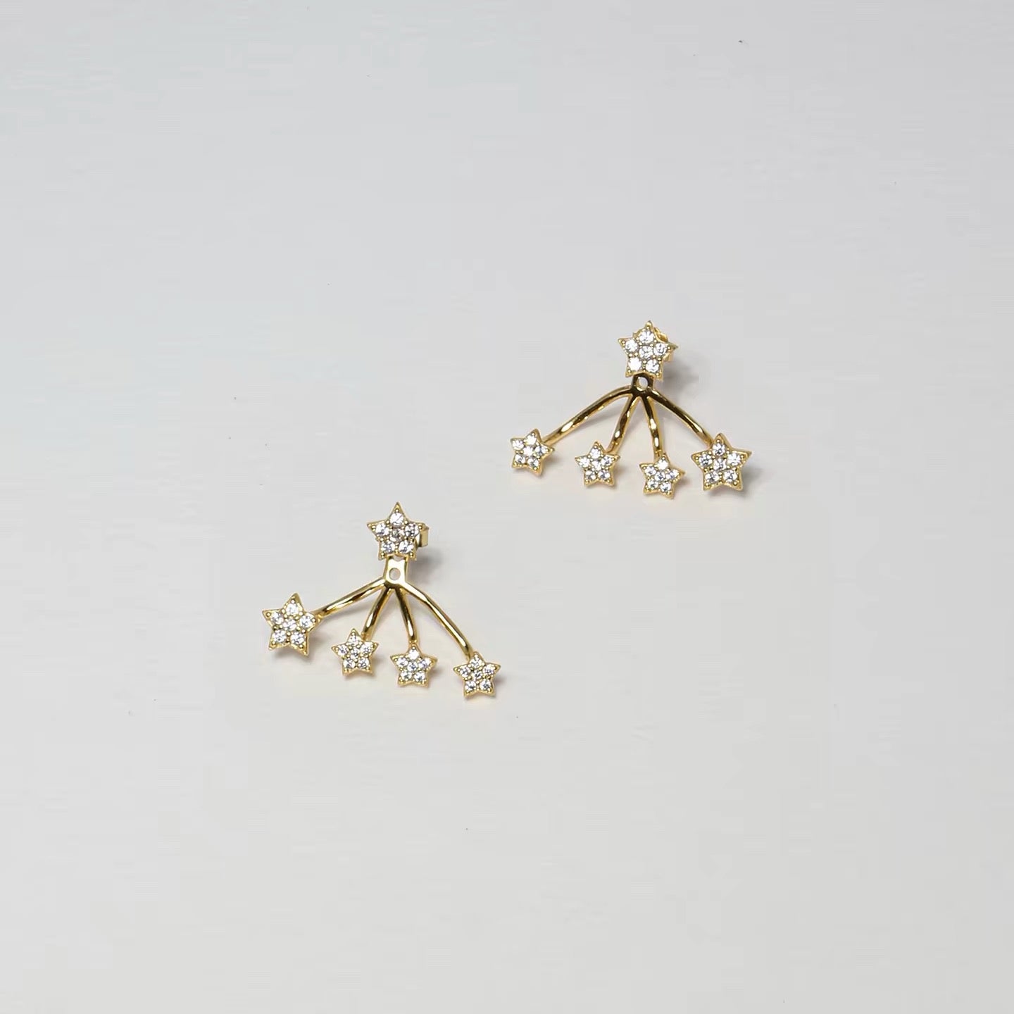 Silver star ear jacket earrings worn in profile