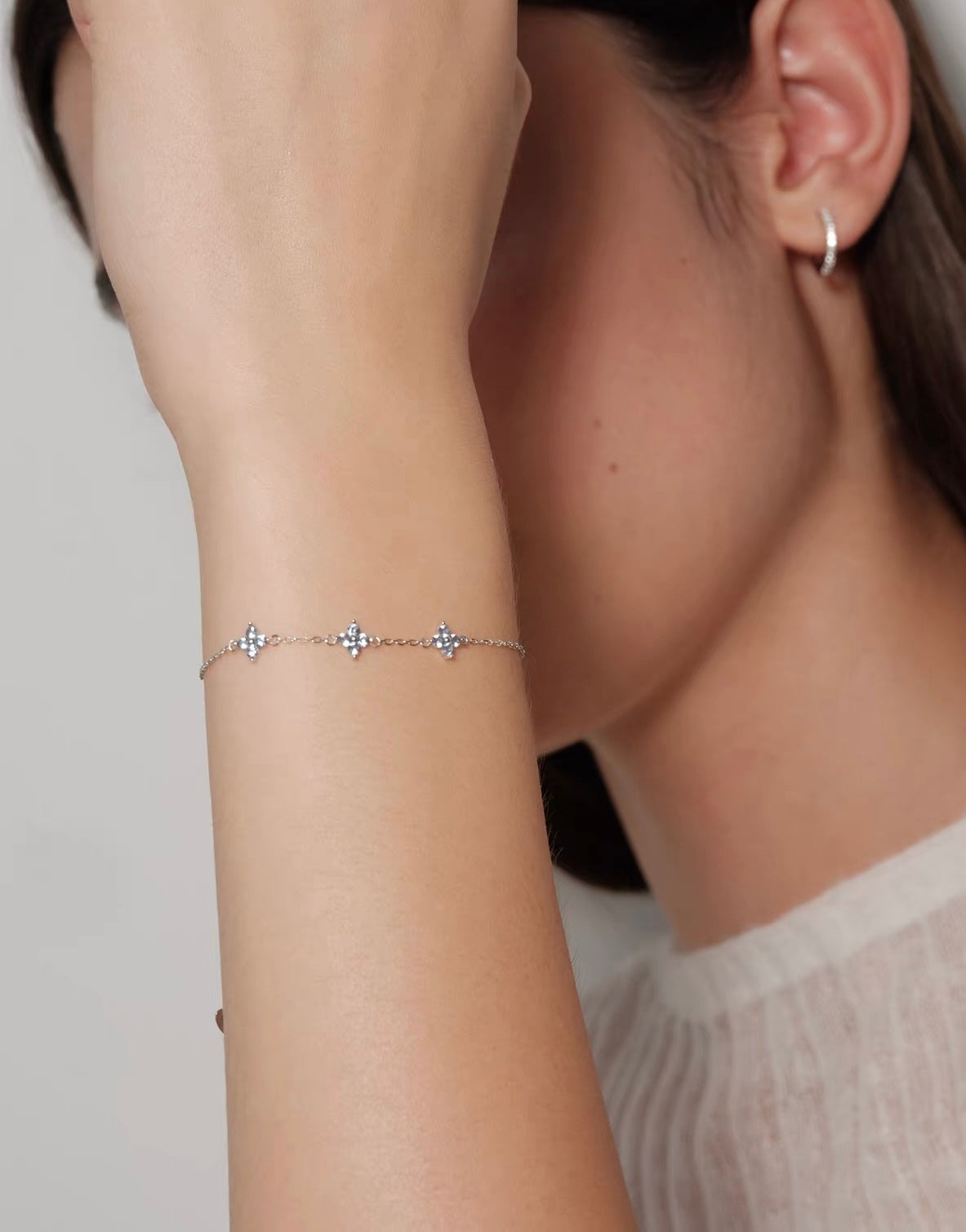Close-up model view of silver Clover Bracelet with pale blue floral stones