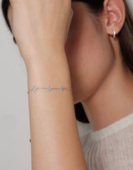 Close-up model view of silver Clover Bracelet with pale blue floral stones