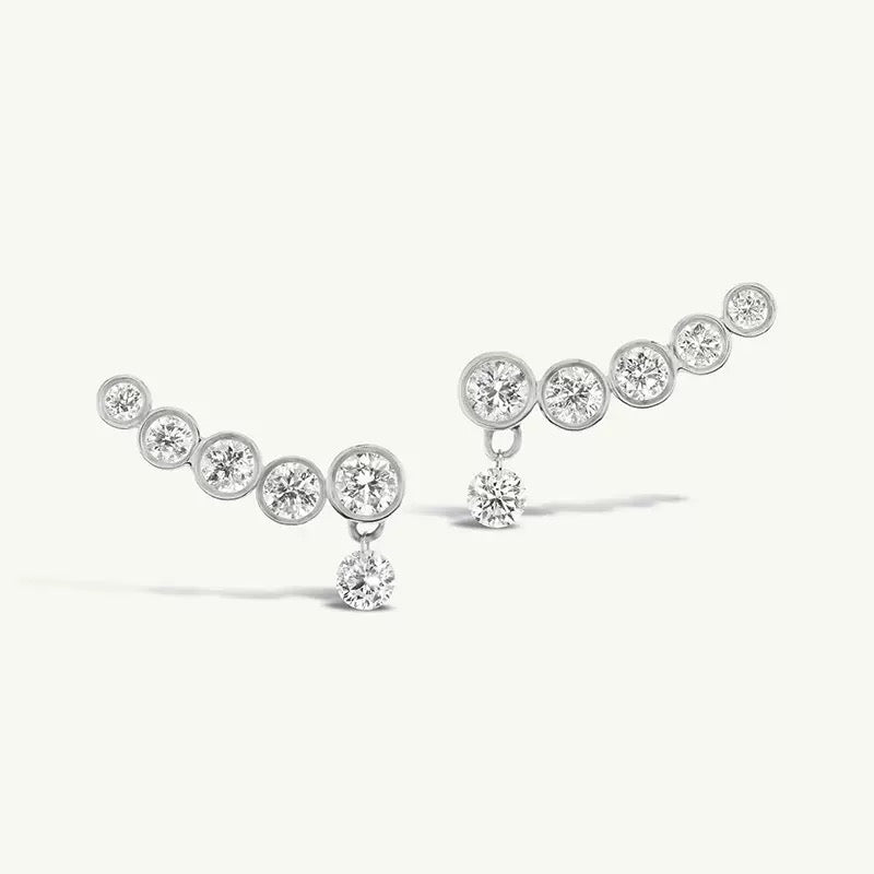 Line Earrings in silver with five graduated bezel-set zirconia stones and a dangling round stone