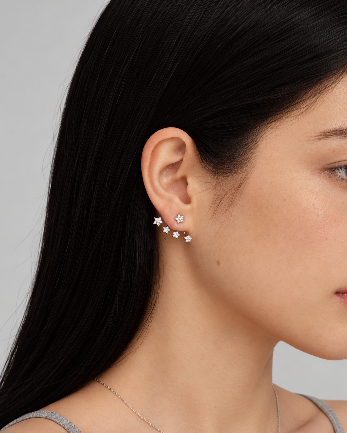 Model wearing silver Nuit Étoilée star ear jacket earrings