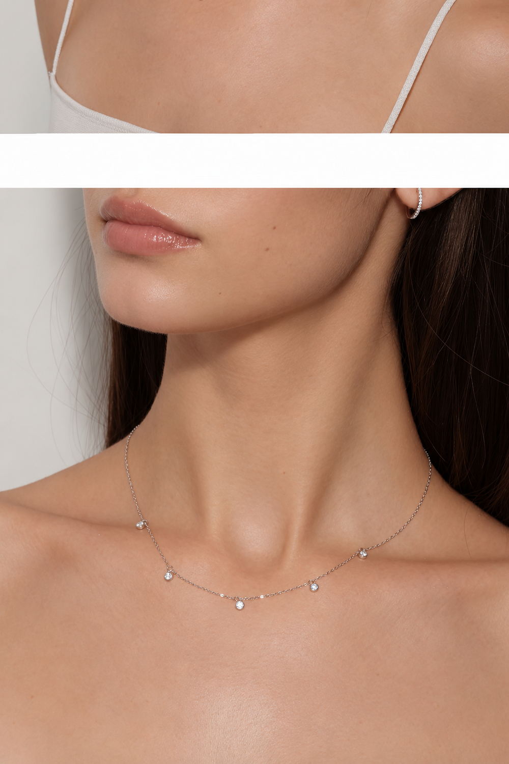 Model wearing Pluie de Lumière Necklace in silver, angled close-up