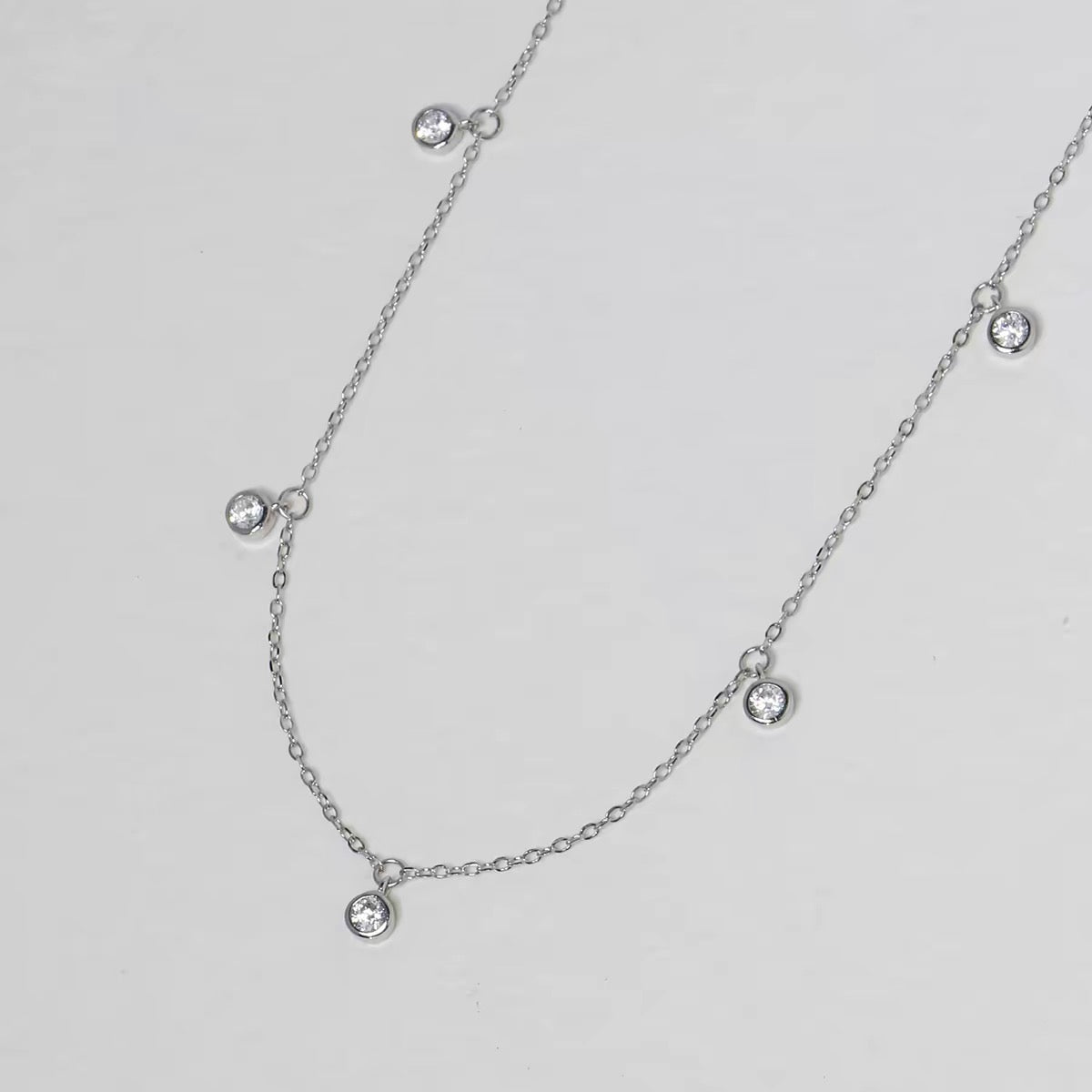 Pluie de Lumière Necklace in silver with five bezel-set zirconia drops